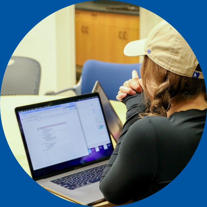 student using laptop at event