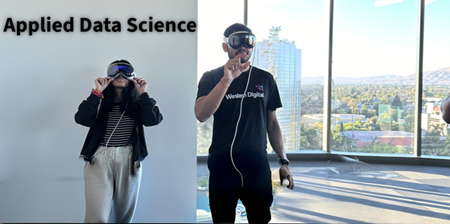 Students with virtual reality devices in front of Department of Applied Data Science wall sign. 