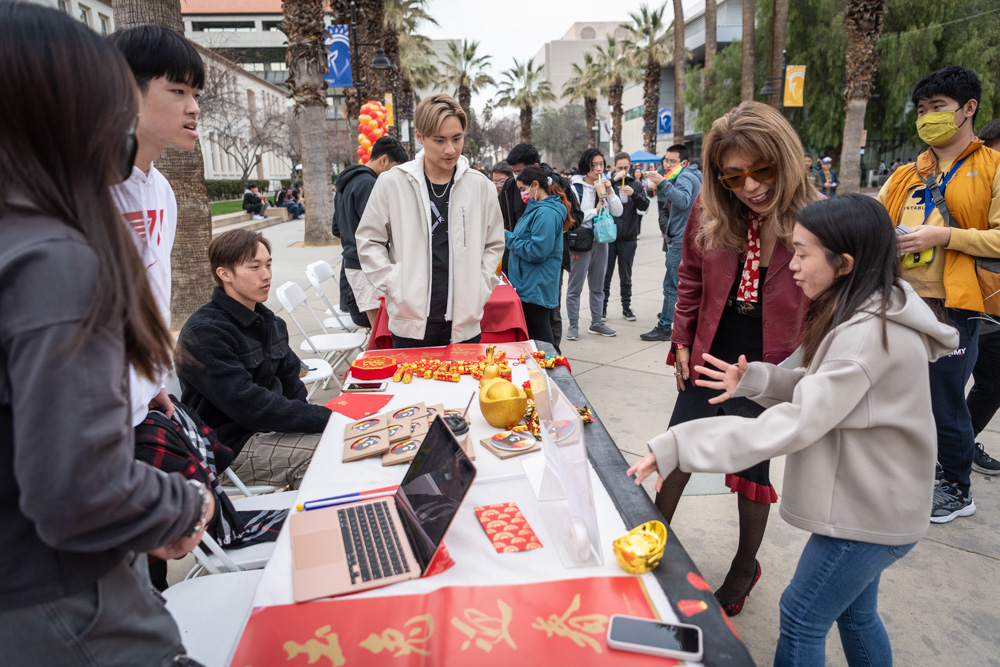 SJSU President speaking with students at the Lunar New Year Celebration.