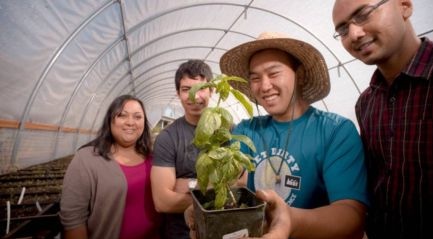 student holding a plant